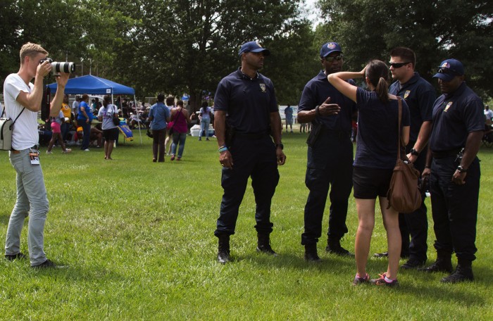 Jon LaFlamme photographs Baton Rouge police officers during the annual "Pack the Park" event in Baton Rouge, Louisiana.Photo by: Claudia Balthazar